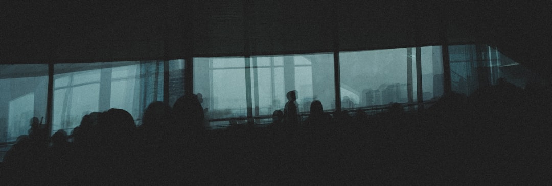 a group of people standing in front of a window