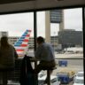 man and woman sitting on chair inside airport