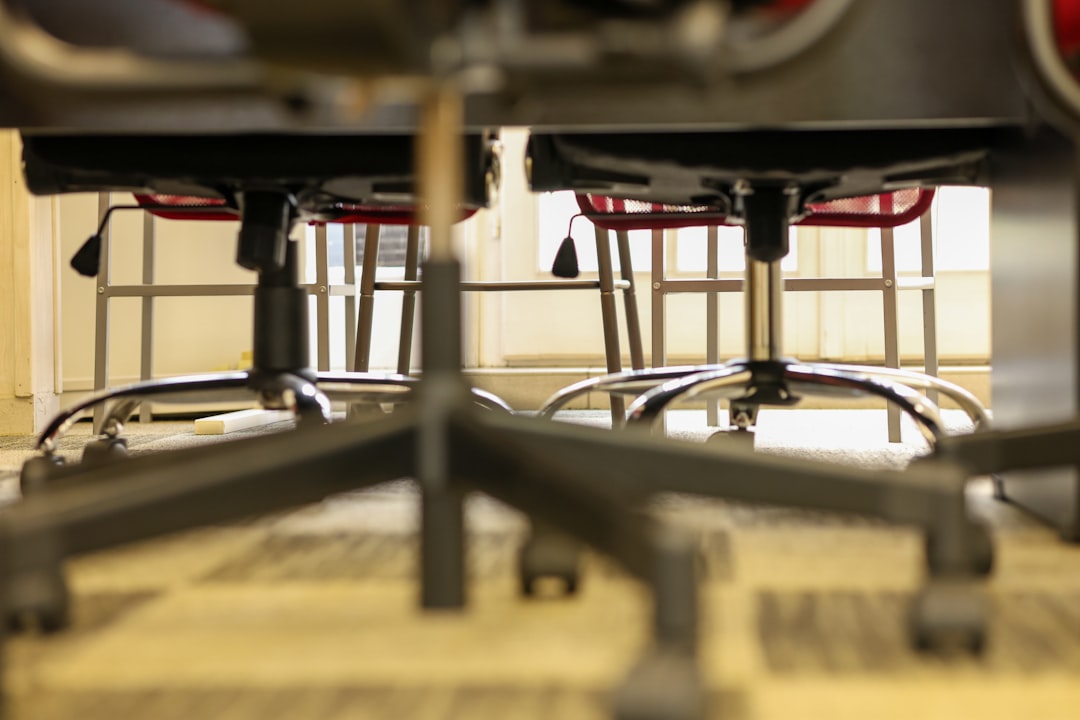 Chairs are lined up under a desk.