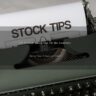 a close up of an old fashioned typewriter with a paper that reads stock tips